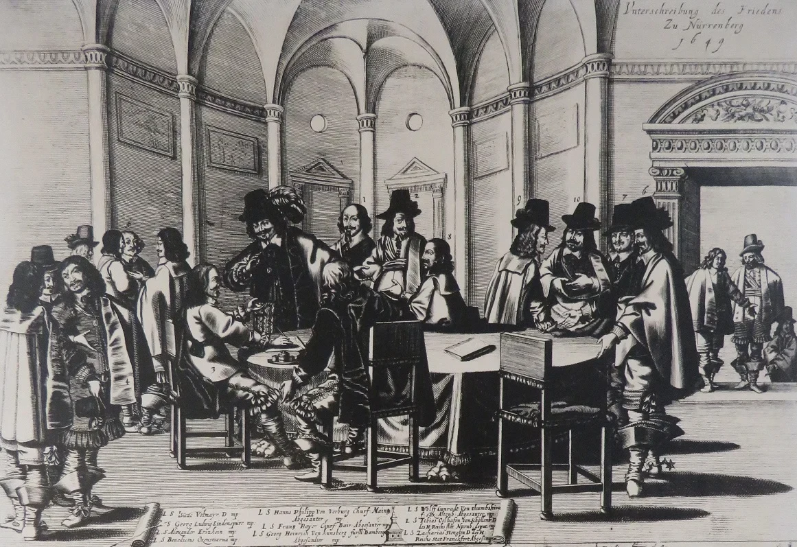 Eine Wissenschaftlerin und ein Wissenschaftler arbeiten hinter einer Glasfassade und mischen Chemikalien mit Großgeräten.